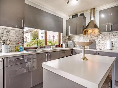 a kitchen with stainless steel cabinets and a sink at Highview in Brodick
