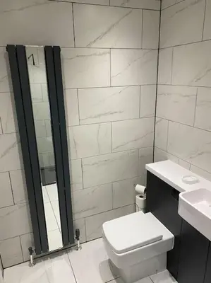 a white bathroom with a toilet and a shower at Perfectly situated luxury 2 bedroom apartment in Glasgow