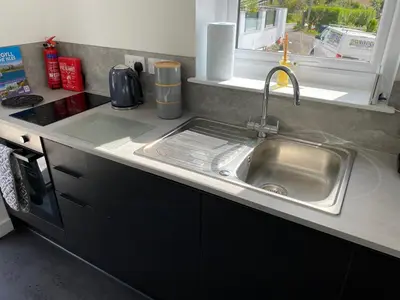 a kitchen counter with a sink and a window at Benollis in Oban