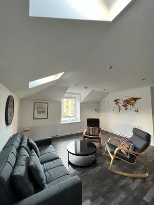 a living room with a couch and a table at Very Central, Charlotte Square, near the Castle in Edinburgh
