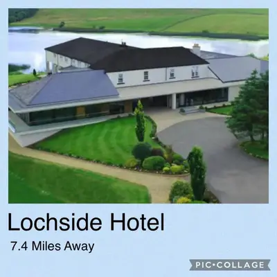 a large house with a driveway in front of it at Maneight Luxury Lodge with hot tub in New Cumnock