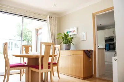 a kitchen and dining room with a table and chairs at Pear Tree Cottage in Limekilns