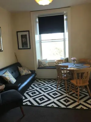 a living room with a couch and a table at Central 3 bedrooms apartment for upto 6 in Edinburgh