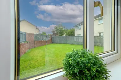a window with a view of a yard at Pure Apartments Commuter- Dunfermline South in Fife