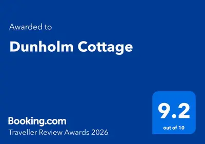 a blue sign that reads dunhillcin coffee at Dunholm Cottage in Skelmorlie