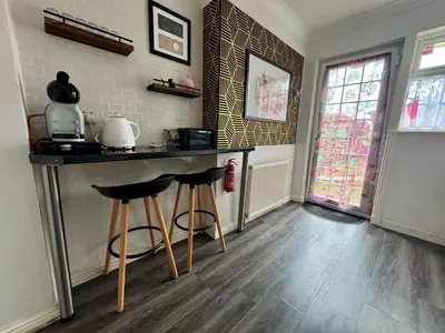 a kitchen with a counter and two bar stools at FINN VILLAGE 