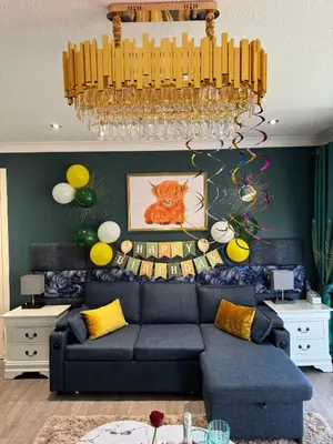 a living room with a blue couch and a chandelier at FINN VILLAGE 