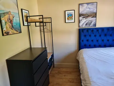 a bedroom with a blue dresser and a blue bed at Kinlochleven Holiday Home in Kinlochleven