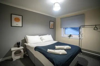 a bedroom with a bed with towels on it at Livi House in Livingston