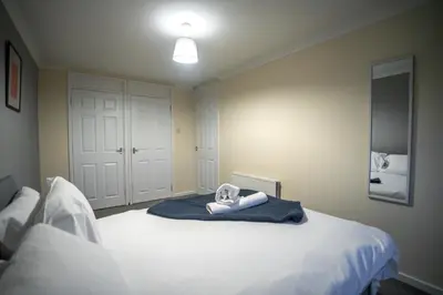 a bedroom with a bed with a towel on it at Livi House in Livingston