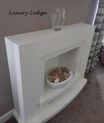 a white shelf with a bowl of nuts on it at Inverbeg Holiday Park in Luss