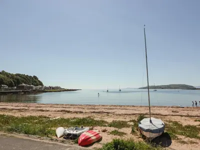 a beach with boats sitting on the sand at Silverbells in Millport