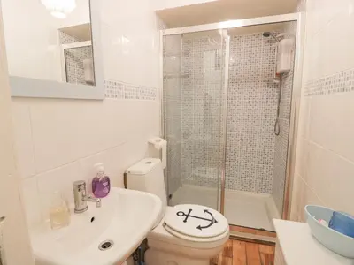 a bathroom with a sink and a toilet and a shower at Silverbells in Millport