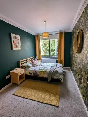 a bedroom with a bed and a window at One The Mews in Glasgow