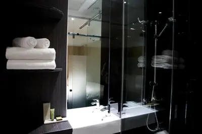 a bathroom with a shower and some towels at The Z Hotel Glasgow in Glasgow
