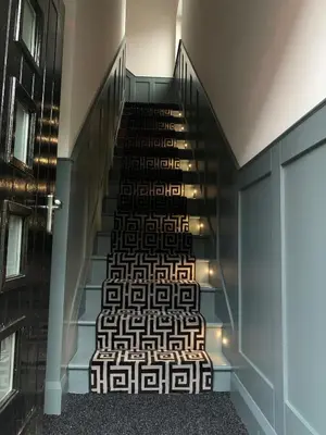 a staircase in a building with a patterned stair case at Hillview in Oban