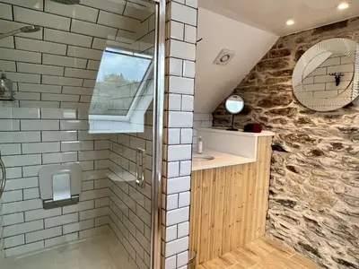 a bathroom with a shower and a sink and a mirror at Tigh Muileann in Killin