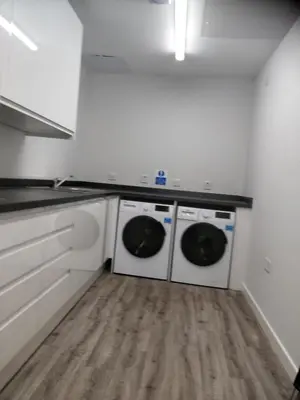 a kitchen with two washer and dryer in a room at The Arches - The Big Yin in Stirling