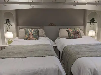 two beds sitting next to each other in a bedroom at Heather Cottage Luss in Luss