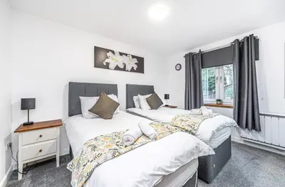 a bedroom with two beds and a window at Super Prime Train Station Inverkeithing by TBA in Inverkeithing