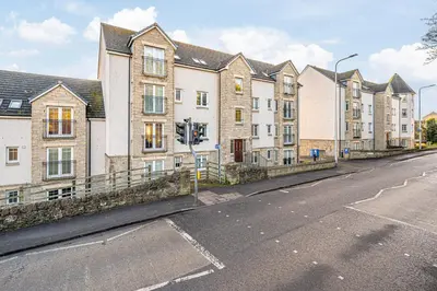 a row of houses on a street with a street light at Super Prime Train Station Inverkeithing by TBA in Inverkeithing