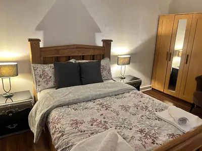 a bedroom with a large bed with two lamps at Royal Apartments Edinburgh in Edinburgh