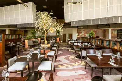 a dining room with tables and chairs in a restaurant at Crowne Plaza Glasgow by IHG in Glasgow