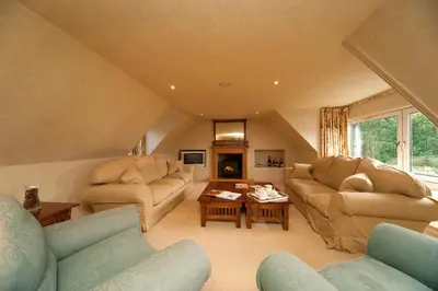 a living room with two couches and a table at Isle of Eriska Hotel Spa & Island in Benderloch