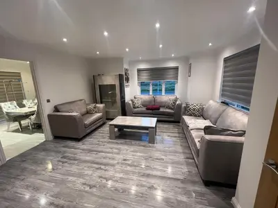 a living room with a couch and a coffee table at Paradise on earth in Garthamlock
