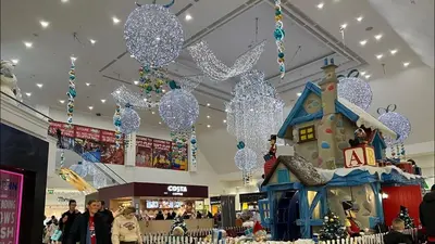 a shopping mall with christmas lights and a house at Paradise on earth in Garthamlock