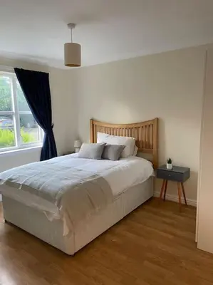 a bedroom with a large bed and a window at 2 bed city centre modern flat in Edinburgh