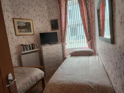 a small room with a bed and a tv at Apartment - Largs - Sleeps 4 - Pet Friendly in Largs
