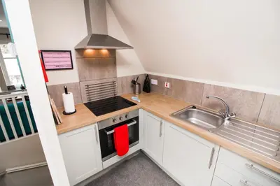 a small kitchen with a sink and a stove at Pheasant lodge - Balmaha 3 bed in Glasgow