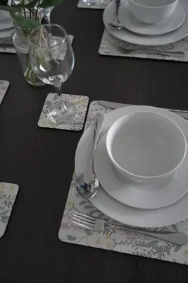 a black table with a white plate and a glass at Dunalastair Apartment in Glasgow