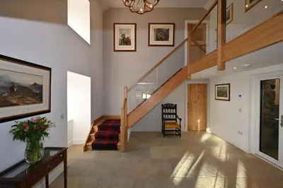 a hallway with a staircase in a house at Kipney Hunting Lodge in Perth