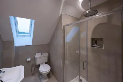 a bathroom with a shower and a toilet and a sink at Kipney Hunting Lodge in Perth