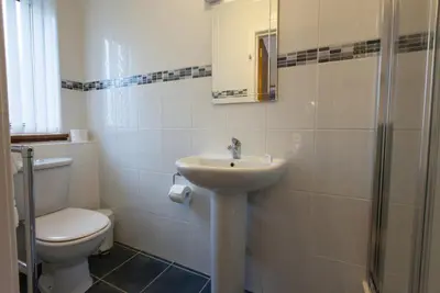 a bathroom with a toilet and a sink and a shower at The Cedars Guest House in Dunoon