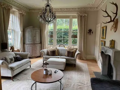 a living room with a couch and a fireplace at Home of Joy - 3 bedroom home with private garden in Glasgow