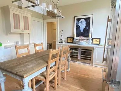 a dining room with a wooden table and chairs at Home of Joy - 3 bedroom home with private garden in Glasgow
