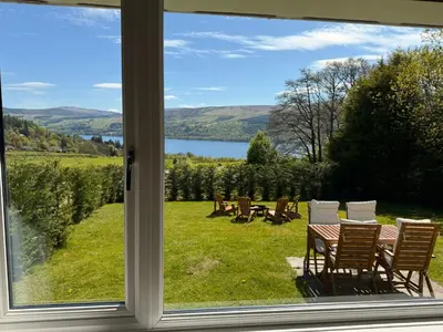 a view of a table and chairs from a window at Beech Cottage in Aberfeldy