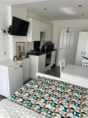 a kitchen with a bed in the middle of a room at Modern Comfy One Bed Apartment - Free Parking in Glasgow