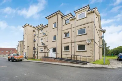 a large brick building on the side of a street at PREMIER - Clydesdale Apartment in Mossend