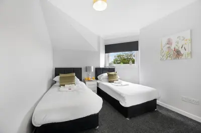 a bedroom with two beds and a window at PREMIER - Clydesdale Apartment in Mossend