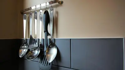 a group of utensils hanging on a wall at Morenish Mews Kenmore Cottage in Morenish