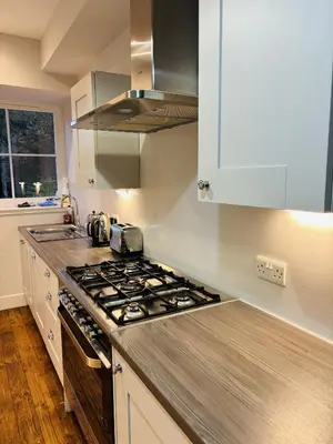 a kitchen with a stove top oven next to a window at Ruchearn in Comrie