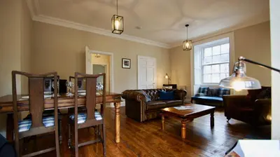 a living room with a couch and a table at Ruchearn in Comrie