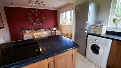 a kitchen with a refrigerator and a washing machine at Tomanour in Comrie