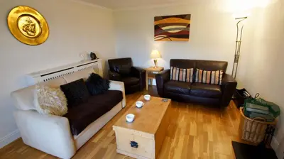 a living room with a couch and a coffee table at View Cottage in Lochearnhead