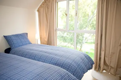 a bed in a bedroom with a window at Lochleven Seafood Cottage in Onich