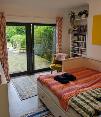 a bedroom with a bed and a sliding glass door at Private room with terrace and free parking in Edinburgh